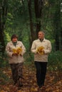 An elderly couple of pensioners walk in an autumn park Royalty Free Stock Photo