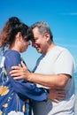 An elderly couple poses for a portrait on the beach Royalty Free Stock Photo