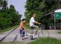 Elderly couple riding a bike together in a sunny park - Eternal love concept