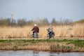 Elderly couple riding bikes at the Dutch Heritage site in Kinderdijk, Netherlands