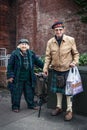 Elderly couple in Scottish dress on the street