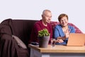 Elderly couple sending their love to their grandchildren. Happy grandmother and grandfather are having video call with their Royalty Free Stock Photo