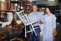 Elderly couple is shopping the old armchair Royalty Free Stock Photo