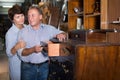 Elderly couple is shopping the old cupboard Royalty Free Stock Photo