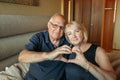 An elderly couple shows a heart with their hands - a sign of love Royalty Free Stock Photo