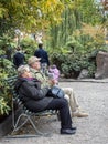 Elderly couple sitting on a bench, enjoying the serene atmosphere