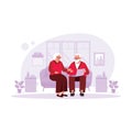 Elderly couple sitting in the living room, watching and enjoying funny memories videos via laptop. Royalty Free Stock Photo