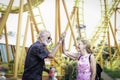 Elderly couple spending time together at theme park on summer weekend, senior people hanging out and having fun at an amusement Royalty Free Stock Photo