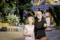 Elderly couple spending time together at theme park on summer weekend, senior people hanging out and having fun at amusement park Royalty Free Stock Photo