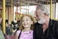 Elderly couple spending time together at theme park on weekend, senior people hanging out and having fun at amusement park. Royalty Free Stock Photo