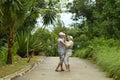 Elderly couple standing embracing in a tropical forest Royalty Free Stock Photo