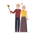 An elderly couple takes a selfie. Old people using modern technology. Elderly man and woman smiling and taking selfie