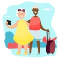 An elderly couple takes a selfie while traveling. Active grandmother and black grandfather travel together. Royalty Free Stock Photo