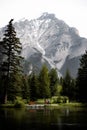 Elderly couple talking with a child on benches in the park on the edge of Banff river with mountain Royalty Free Stock Photo