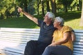 Elderly couple talking resting sit on bench in park Royalty Free Stock Photo