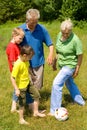 Elderly couple with their grandchildren playing Royalty Free Stock Photo