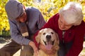 Elderly couple with their pet dog Royalty Free Stock Photo