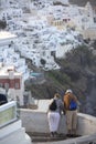 Elderly couple in Thira on Santorini. Tourism, travel and people concept - happy senior couple