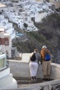Elderly couple in Thira on Santorini. Tourism, travel and people concept - happy senior couple