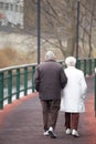 An elderly couple walking along a path. La Vella city, Andorra