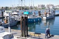 Elderly couple walking by fishing boats