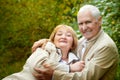 Elderly couple walking in the park on an autumn day Royalty Free Stock Photo