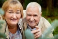 Elderly couple walking in the park on an autumn day Royalty Free Stock Photo