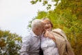 Elderly couple walking in the park on an autumn day Royalty Free Stock Photo