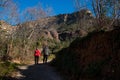 Elderly couple walks outdoors trekking in the catalan landscape mountains and meadows in Sant Miquel del Fai in the Catalonia