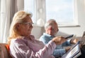 Elderly couple watching tv and reading newspaper Royalty Free Stock Photo