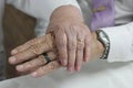 Elderly Couple on wedding day. 80 year old couple holding hands showing their wedding rings after wedding Royalty Free Stock Photo