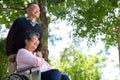 Elderly couples or caregivers take care of the patient in a wheelchair. Concept of a happy retirement with care from a caregiver Royalty Free Stock Photo