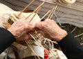 Elderly craftswoman producing a wicker basket
