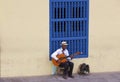 Cuban Man Sitting and Playing Guitar on Streets of Old Town Trinidad Cuba Royalty Free Stock Photo