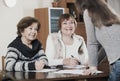 Elderly cute positive women making will at public notary office Royalty Free Stock Photo