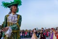 Elderly dancers in bright historical medieval costumes, dancing in the square in summer