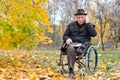 Elderly disabled man in a wheelchair in a park Royalty Free Stock Photo