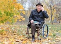 Elderly disabled man in a wheelchair in a park