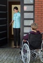 Elderly disabled woman enters the house Royalty Free Stock Photo