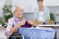 elderly disabled woman sorting laundry Royalty Free Stock Photo