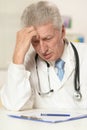 Elderly doctor at a table