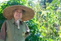 elderly elder woman senior gardener farmer resting in garden