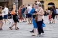 Elderly elegant couple, tourists walking in the street, wearing face masks during covid 19 quarantine in Italy.