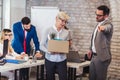 Elderly employee leaving office with box full of belongings. Royalty Free Stock Photo