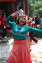 An elderly ethnic lady dancing and smiling to the camera