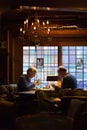 Elderly European couple dining at a romantic restaurant