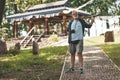 An elderly European tourist against the background of an ancient Asian temple. One day trip