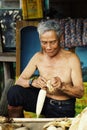 elderly farmer man cleaning the corn for the market