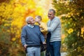 Father adult son and grandson out for a walk in the park