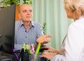 Elderly female doctor talking with mature male patient Royalty Free Stock Photo